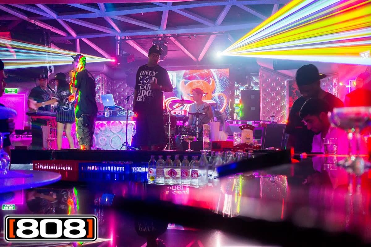Laser beams sweep over the 808 stage during a live band set